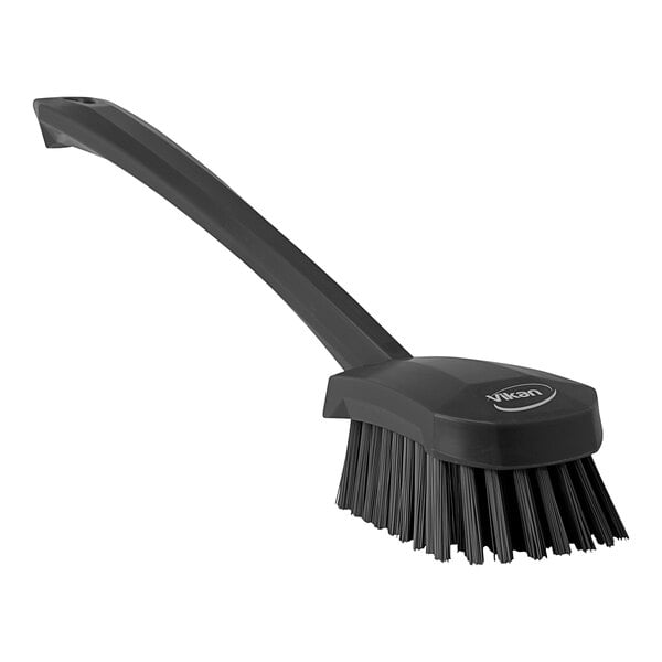 A black Vikan washing brush with a long handle.