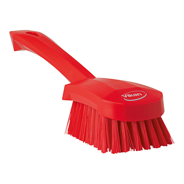 A red Vikan washing brush with a handle.