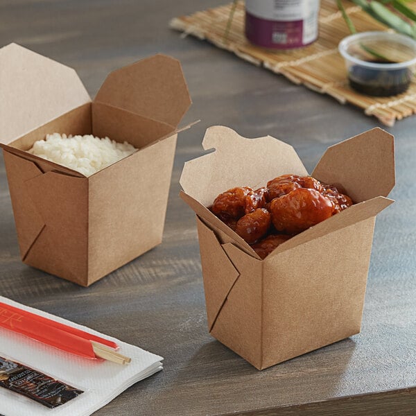 Two Emperor's Select Chinese take-out containers with food in them on a table.