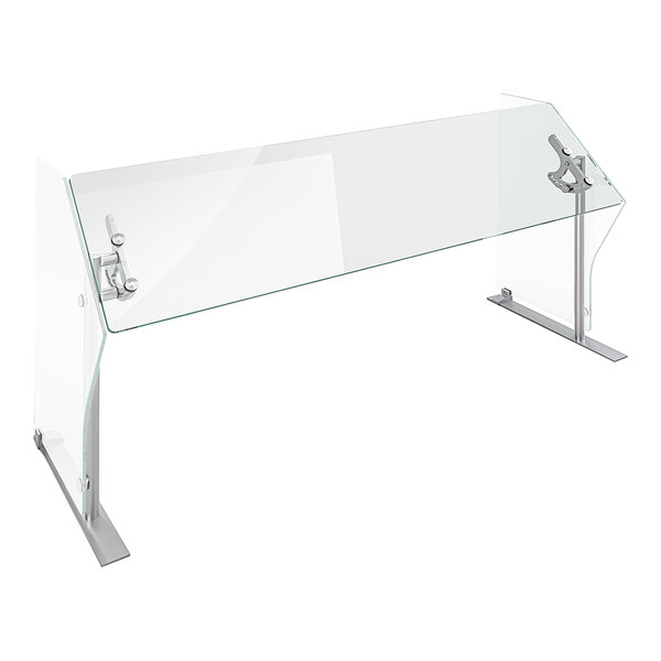 A Spring USA glass food shield on a metal stand over a counter.