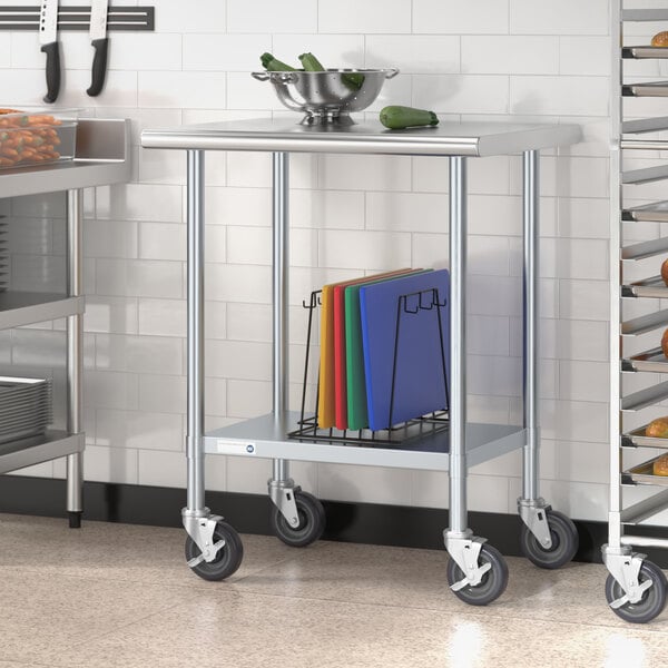 A Steelton stainless steel work table with an undershelf and casters holding a bowl of vegetables.