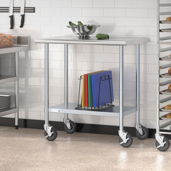 A Steelton stainless steel work table with undershelf and casters holding a bowl of vegetables.