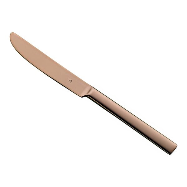 A WMF Unic Copper stainless steel table knife with a long, thin metal handle with a rose gold finish.