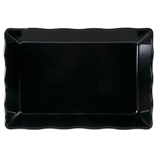 A black rectangular tray with scalloped edges.