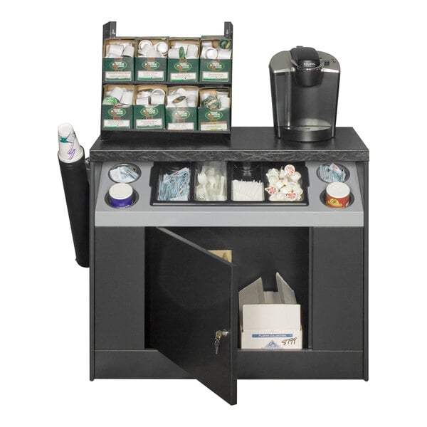 An All State Manufacturing coffee stand with condiment tray and cylinder compartments on a black and grey counter with a black door open.