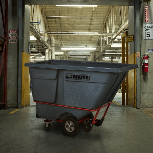 A large grey Rubbermaid tilt truck in a warehouse.