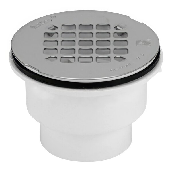 A white Oatey PVC shower drain with a silver round strainer grid.