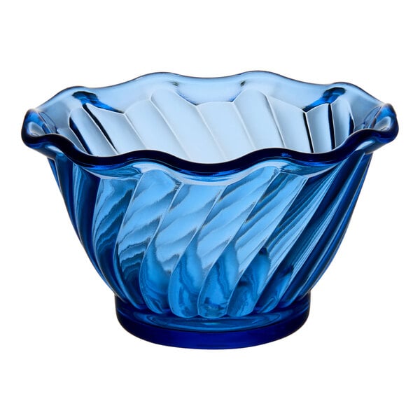 A blue plastic dessert dish with a wavy edge.