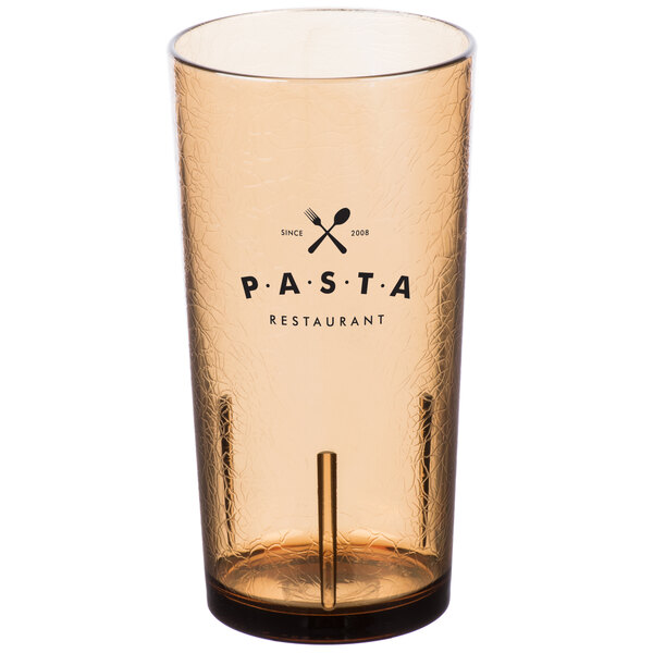 A close-up of a light amber Cambro plastic tumbler with the word "Pasta" on it.