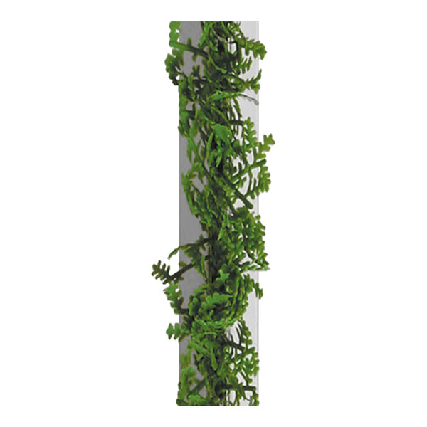 A close-up of a Dalebrook artificial green melamine cypress divider with white base growing on a white surface.