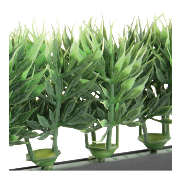 A close-up of a Dalebrook artificial green melamine spruce divider with black base filled with artificial green plants.