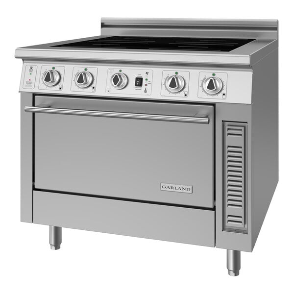 A stainless steel commercial electric induction range and convection oven with five control knobs and a large oven door.