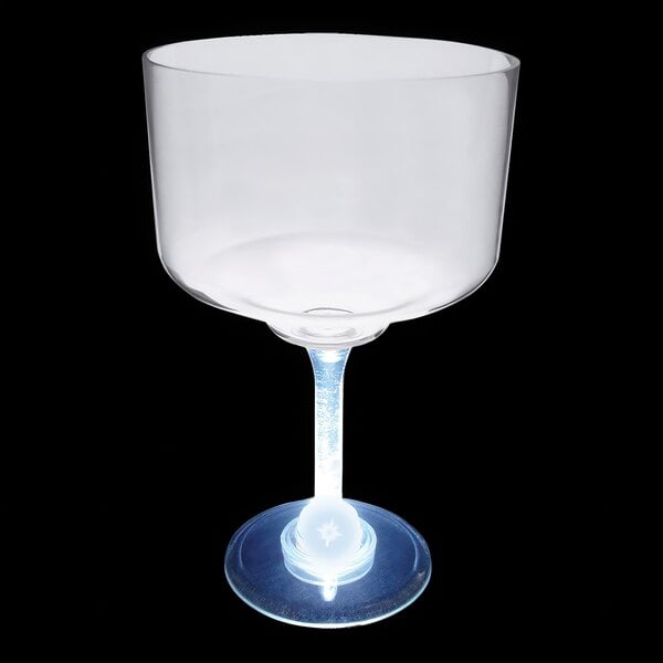 A clear plastic margarita cup with a white LED light on the bottom.