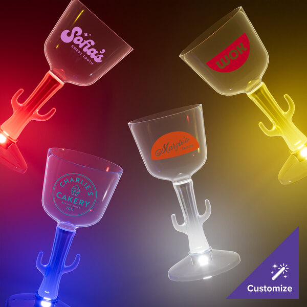 A group of clear plastic wine cups with white LED lights on the cactus stems.