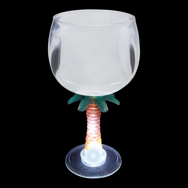 A clear plastic goblet with a palm tree stem and white LED light.