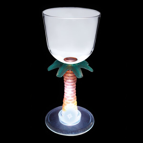 A clear plastic wine cup with a palm tree shaped stem lit up with a white LED light.