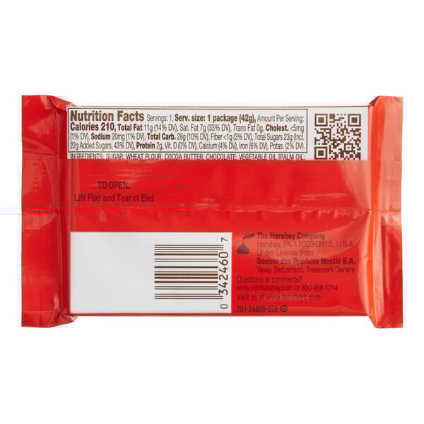 A close-up of a red KIT KAT milk chocolate bar package with black text and a QR code.