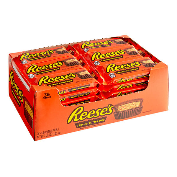 A box of REESE'S Milk Chocolate Peanut Butter Cups on a table.