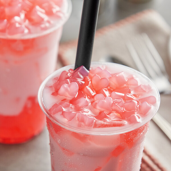 Two cups of pink drinks with Fanale Sakura cherry blossom heart-shaped jelly toppings and black straws.