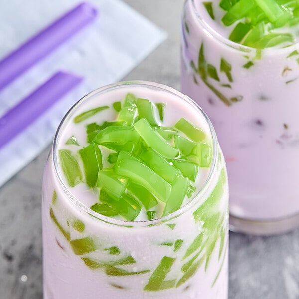 Two glasses of milkshakes with Fanale green apple jelly toppings.