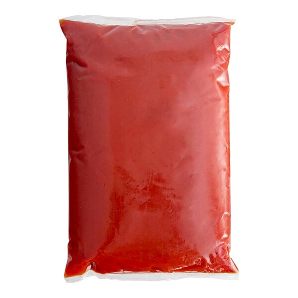 A red plastic bag of Red Gold tomato ketchup on a white background.