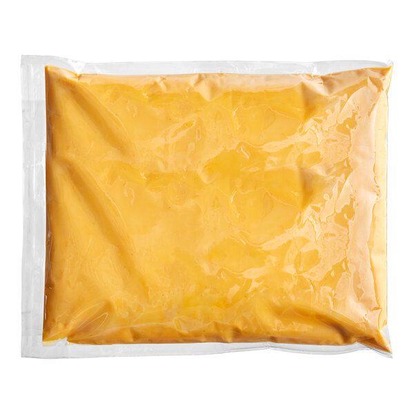 A white plastic pouch of Muy Fresco Plant-Based Nacho-Style Vegan Cheese Sauce.