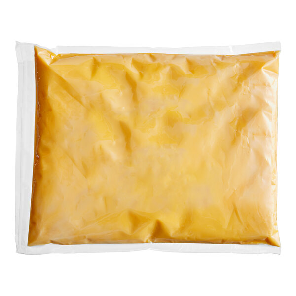 A white plastic bag of Muy Fresco Plant-Based Cheddar-Style vegan cheese sauce.