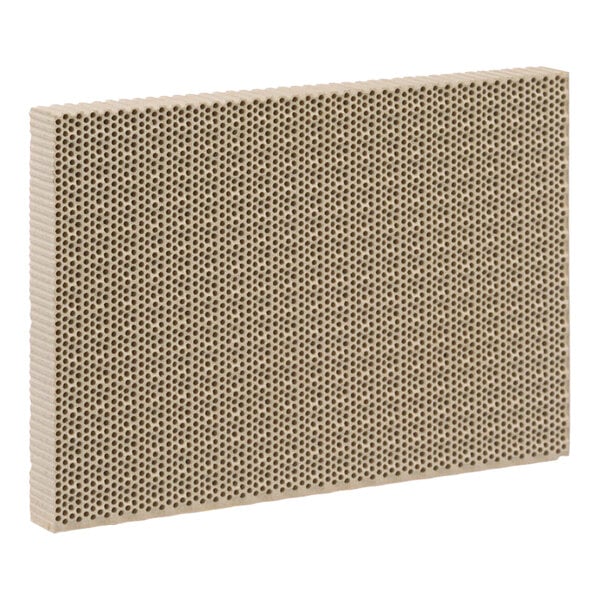 A beige ceramic tile with holes on the surface.