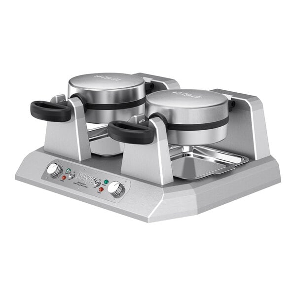 A Waring double Belgian waffle maker on a stainless steel stand.