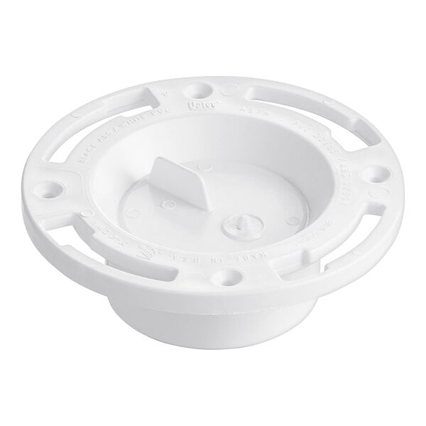 A white plastic round water closet flange cover with holes in it.