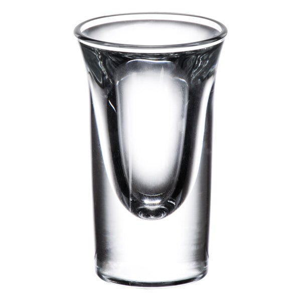 A close-up of a Libbey tall shot glass with a clear rim.