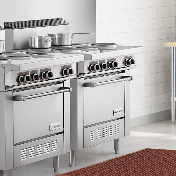 A commercial stainless steel electric restaurant range with six sealed burners and two standard ovens.