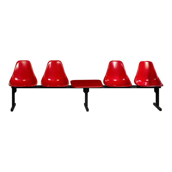 A row of three red Sol-O-Matic chairs with black bases and a table.