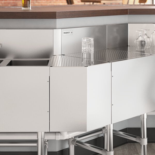 A Regency stainless steel counter with a 45-degree angle on it.