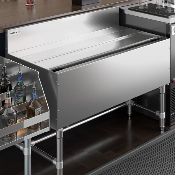 A stainless steel sliding lid for a Regency underbar ice bin.