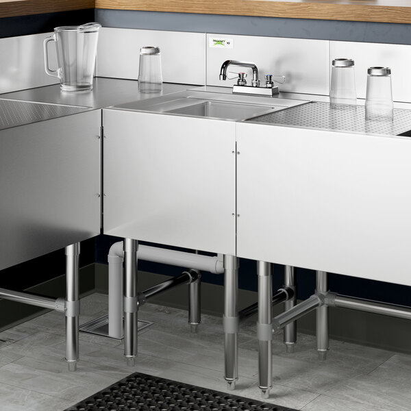 A Regency stainless steel underbar hand sink with a swivel faucet over it.