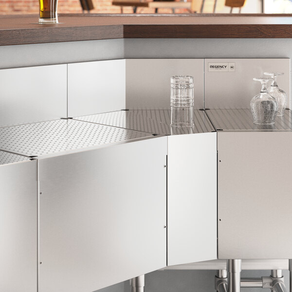 A Regency stainless steel 45-degree angle underbar filler on a metal surface.