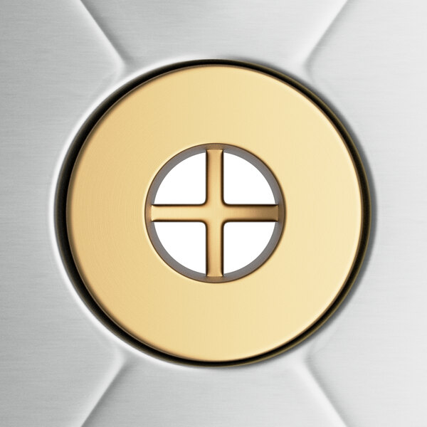 A circular gold object with a cross in the center.