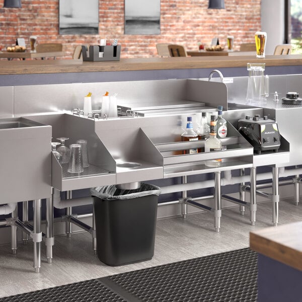 A Regency stainless steel combination cocktail station with a drainboard on a counter.