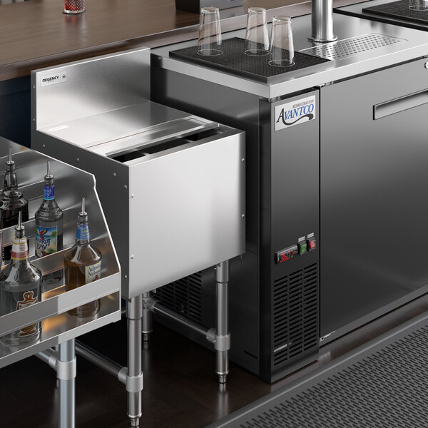 A Regency stainless steel sliding lid on an underbar ice bin.