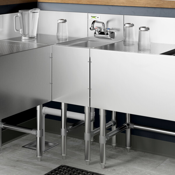 A Regency stainless steel underbar hand sink with a swivel faucet over a counter.
