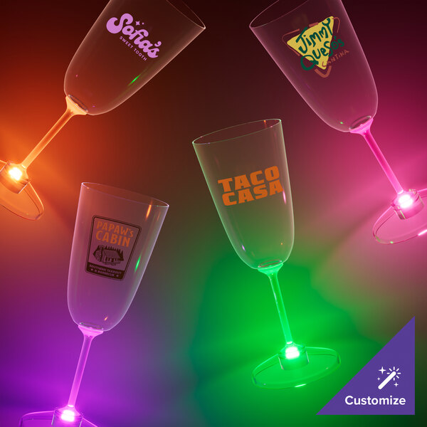 A close-up of a customizable plastic champagne cup with an orange LED light.