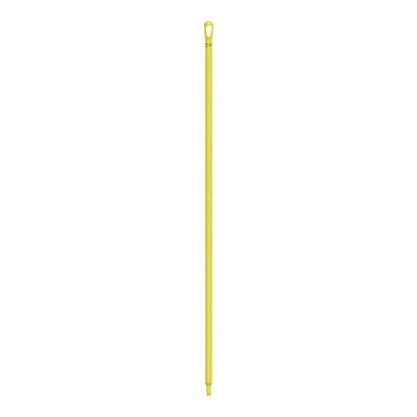 A yellow plastic stick with a hole.