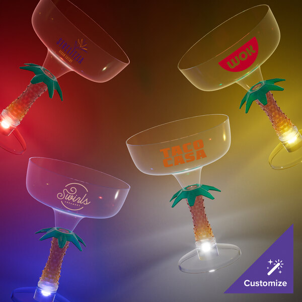 A close-up of a customizable plastic margarita cup with a yellow LED palm tree stem.