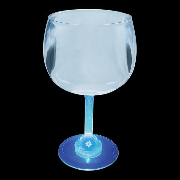 A close up of a clear plastic goblet with a blue LED light in the base.
