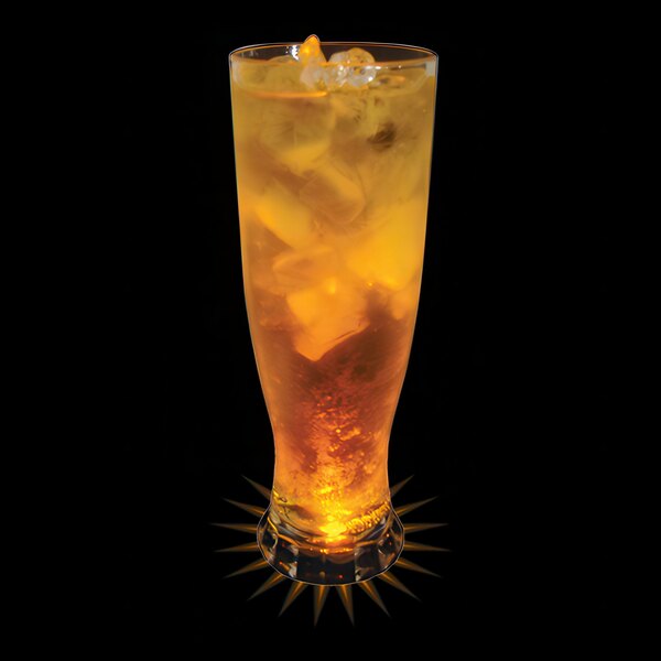 A customizable plastic pilsner cup with yellow LED light filled with a drink and ice on a table.