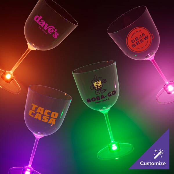 A close-up of three 14 oz. plastic goblets with green LED lights.