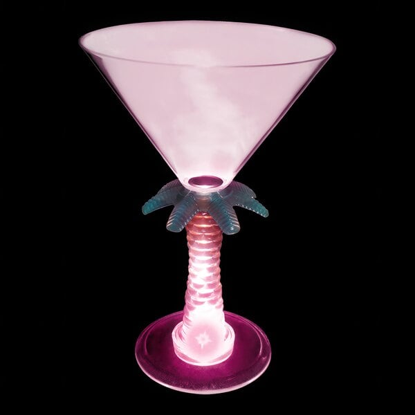 A pink plastic martini glass with a palm tree stem and a pink LED light.