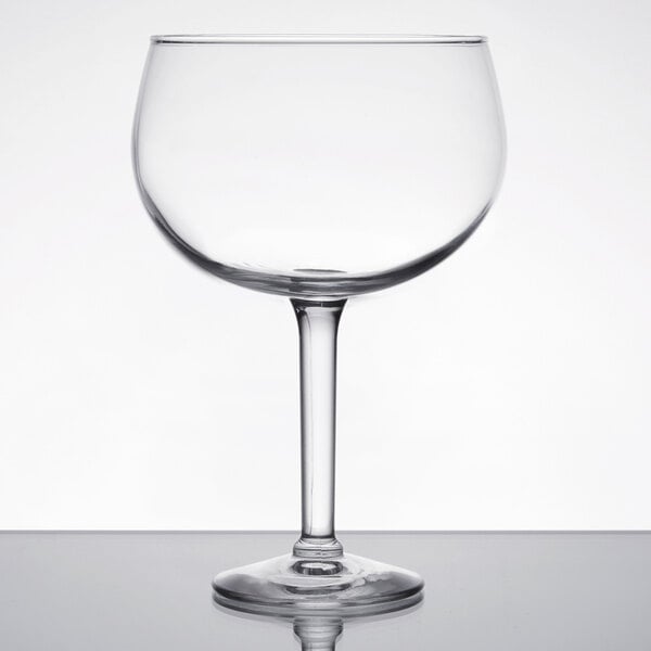 A Libbey Magna Grande margarita glass with a stem on a table.