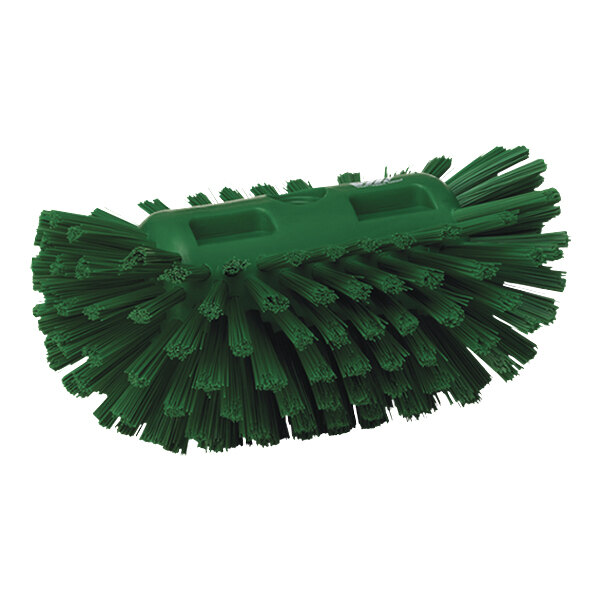 A close-up of a green Vikan tank brush head with stiff bristles.